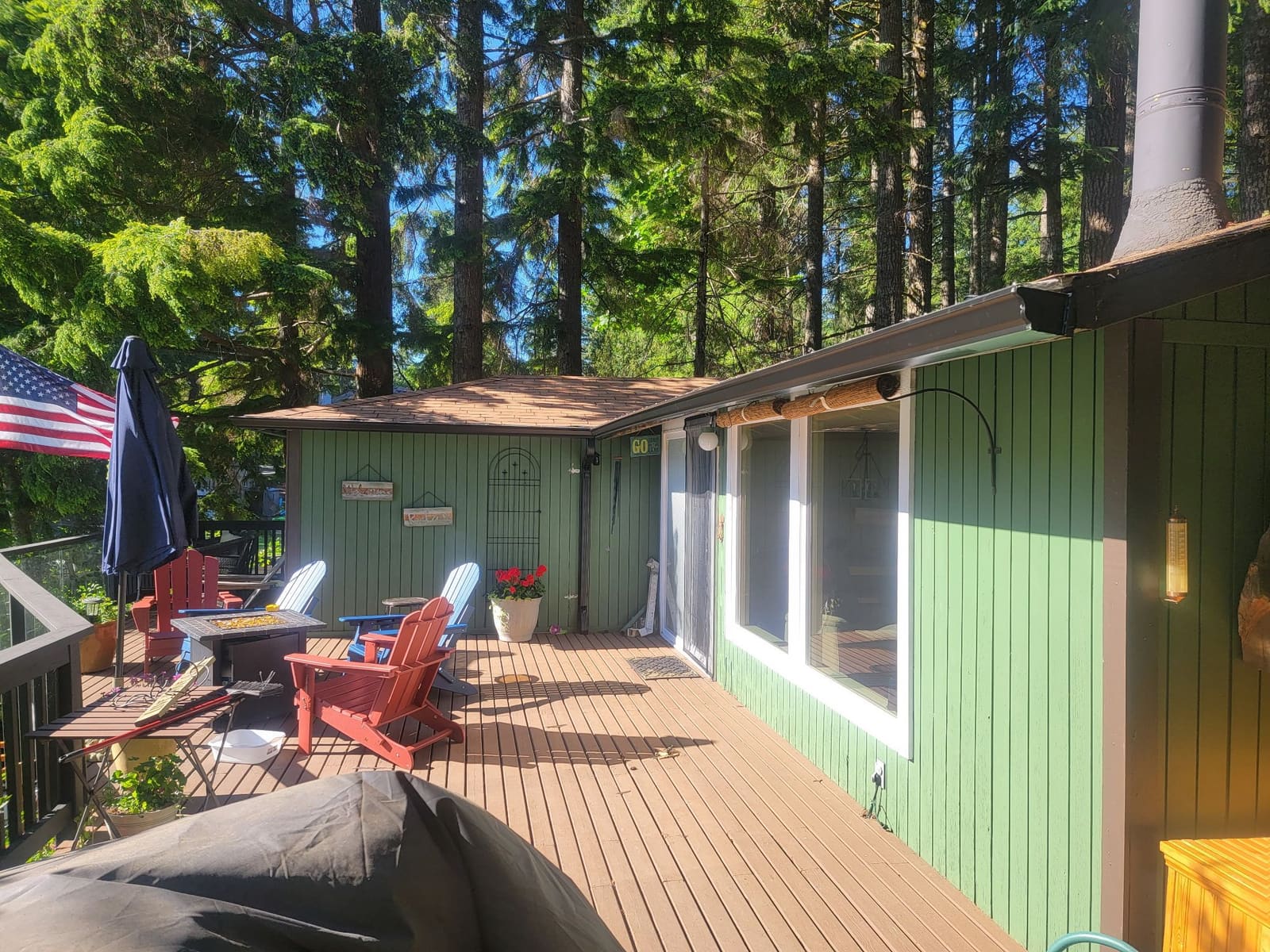 Seamless gutter replacement on a white ranch home with green lawn.
